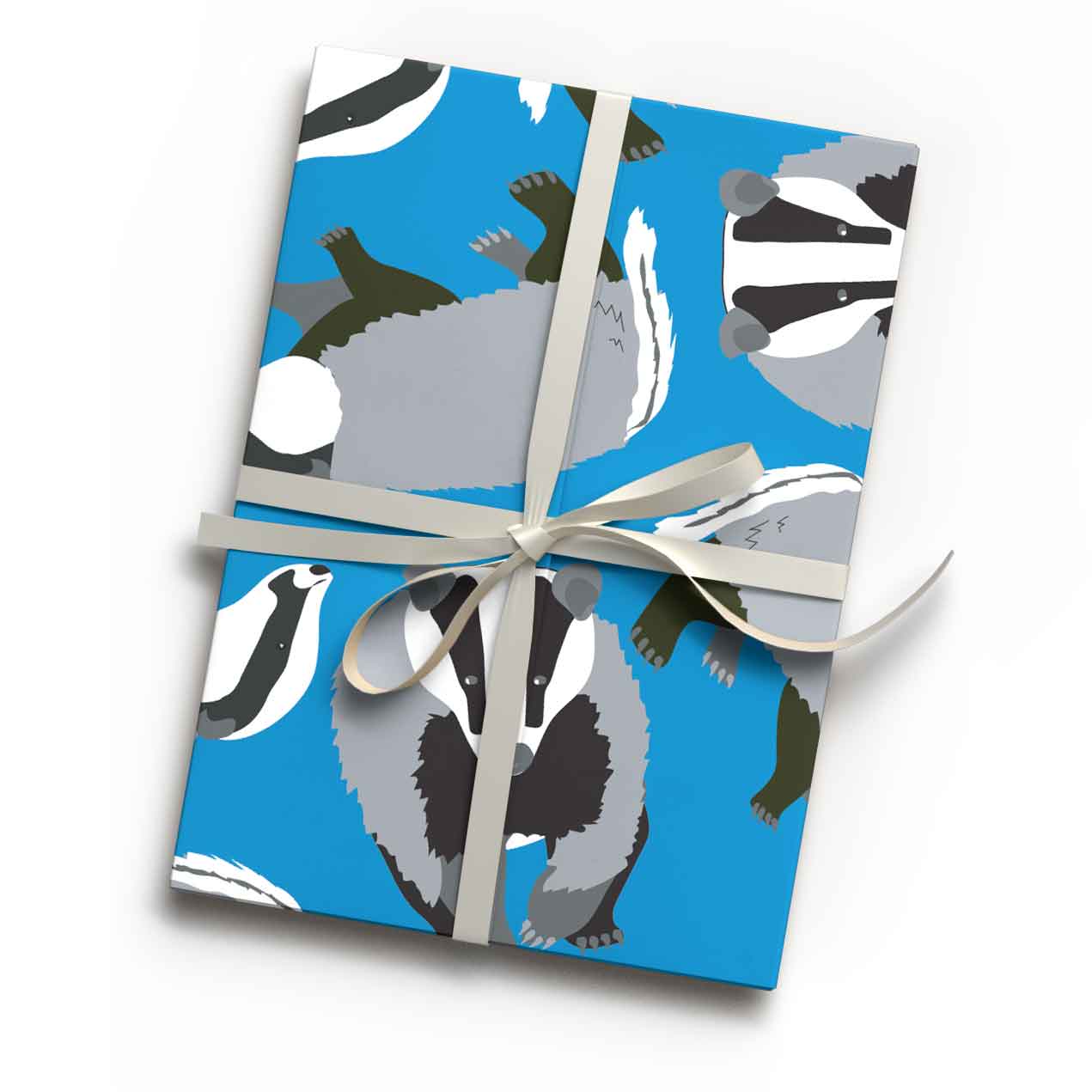 Bright blue badger animal print luxury gift wrap sheet shown wrapping a gift