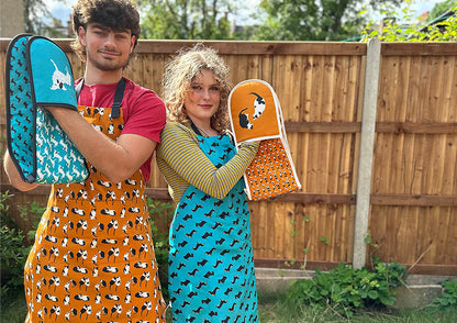 Cats and Dogs aprons and oven gloves worn by models