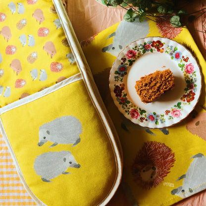 Hedgehog oven gloves and tea towel shown with freshly baked cake on plate  Photo credit @rachelandthelittlebirds