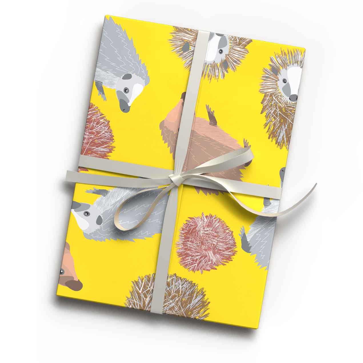 Bright yellow hedgehog animal print luxury gift wrap sheet shown wrapping a gift