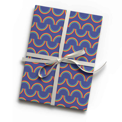 Vibrant rainbow stripe  print luxury gift wrap sheet shown wrapping a gift