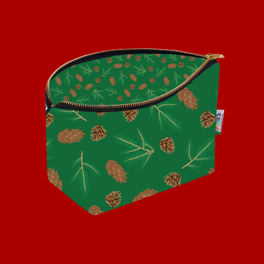 Green Really Useful Bag covered in fir and spruce cones and sprigs