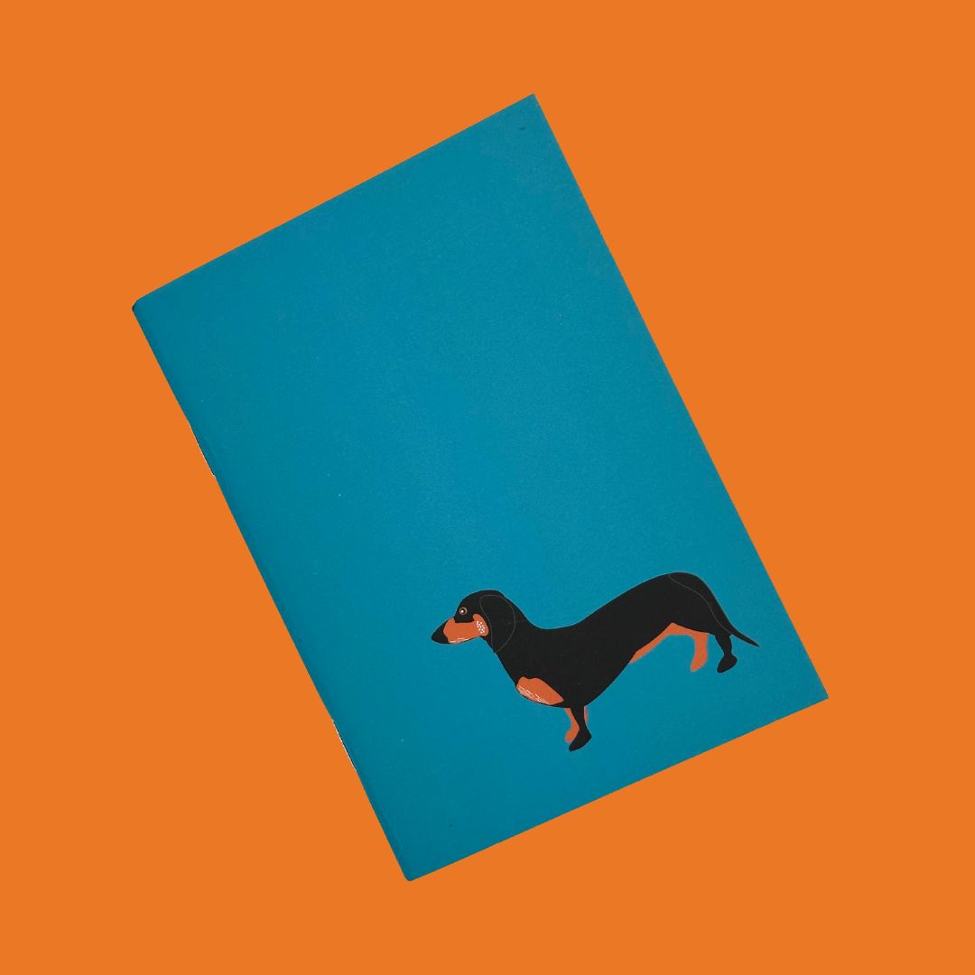 Dachshund petrol blue pocket sized notebook with 36 plain pages printed with plant based inks on recycled paper at a local carbon neutral printers